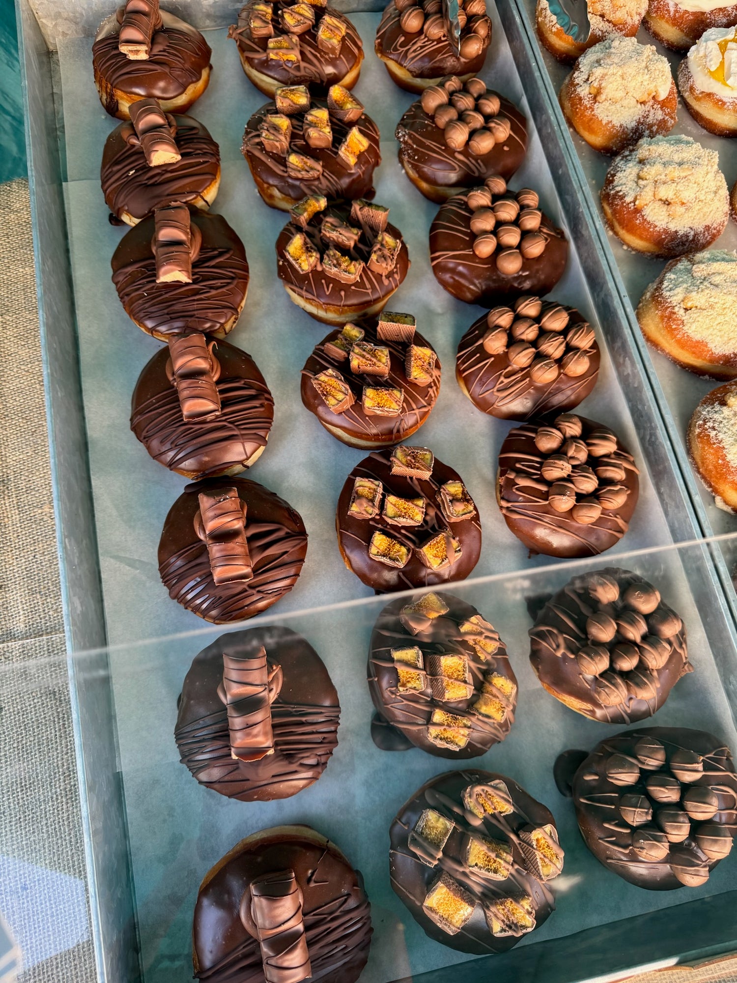 Chocolate doughnuts on display in a shop